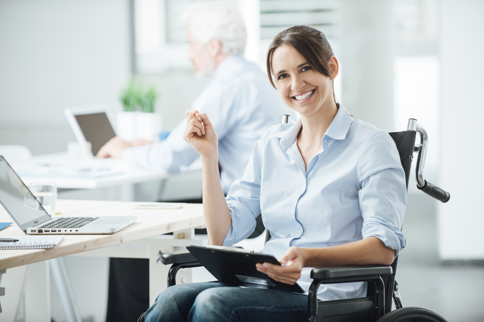 Happy office worker in wheelchair